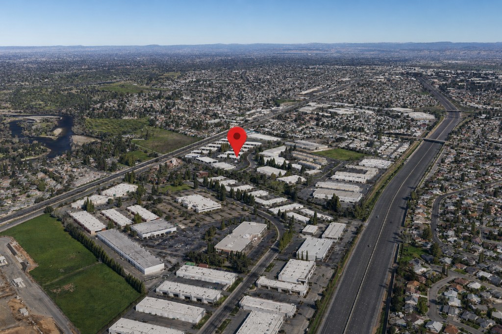 Aerial view of a vast market area with commercial buildings and residential neighborhoods